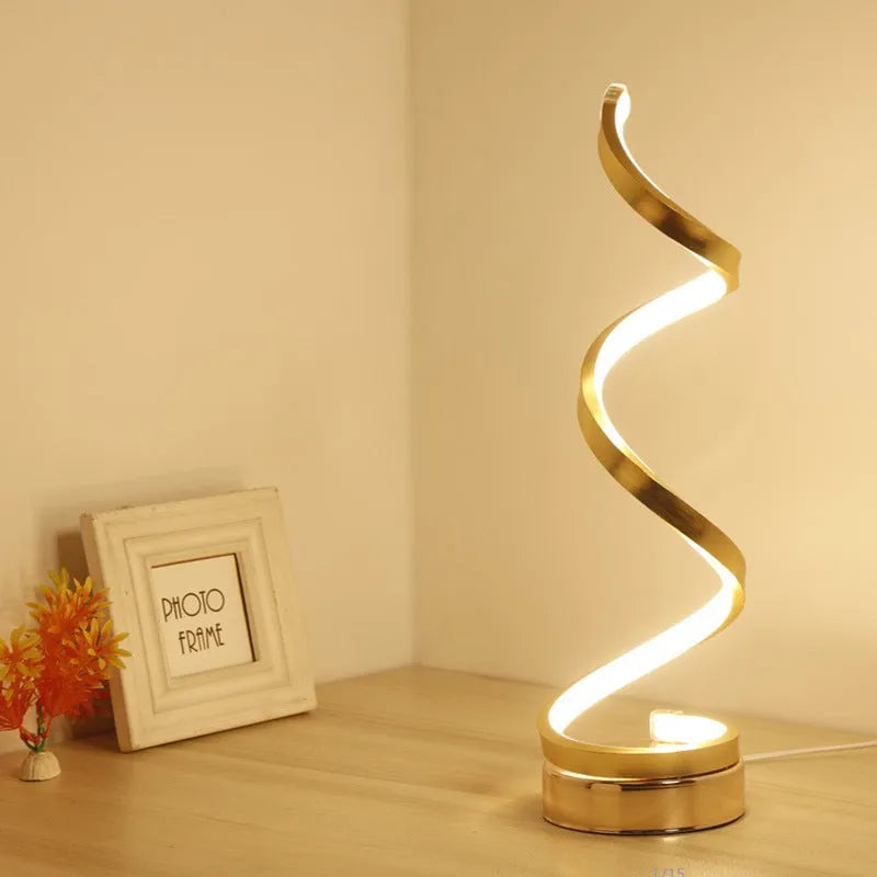 Minimalist black LED table lamp with aluminium shade on bedside table