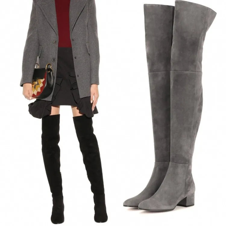 Grey women's suede flat over-the-knee boots with a pointed toe and low thick heel on a neutral background.