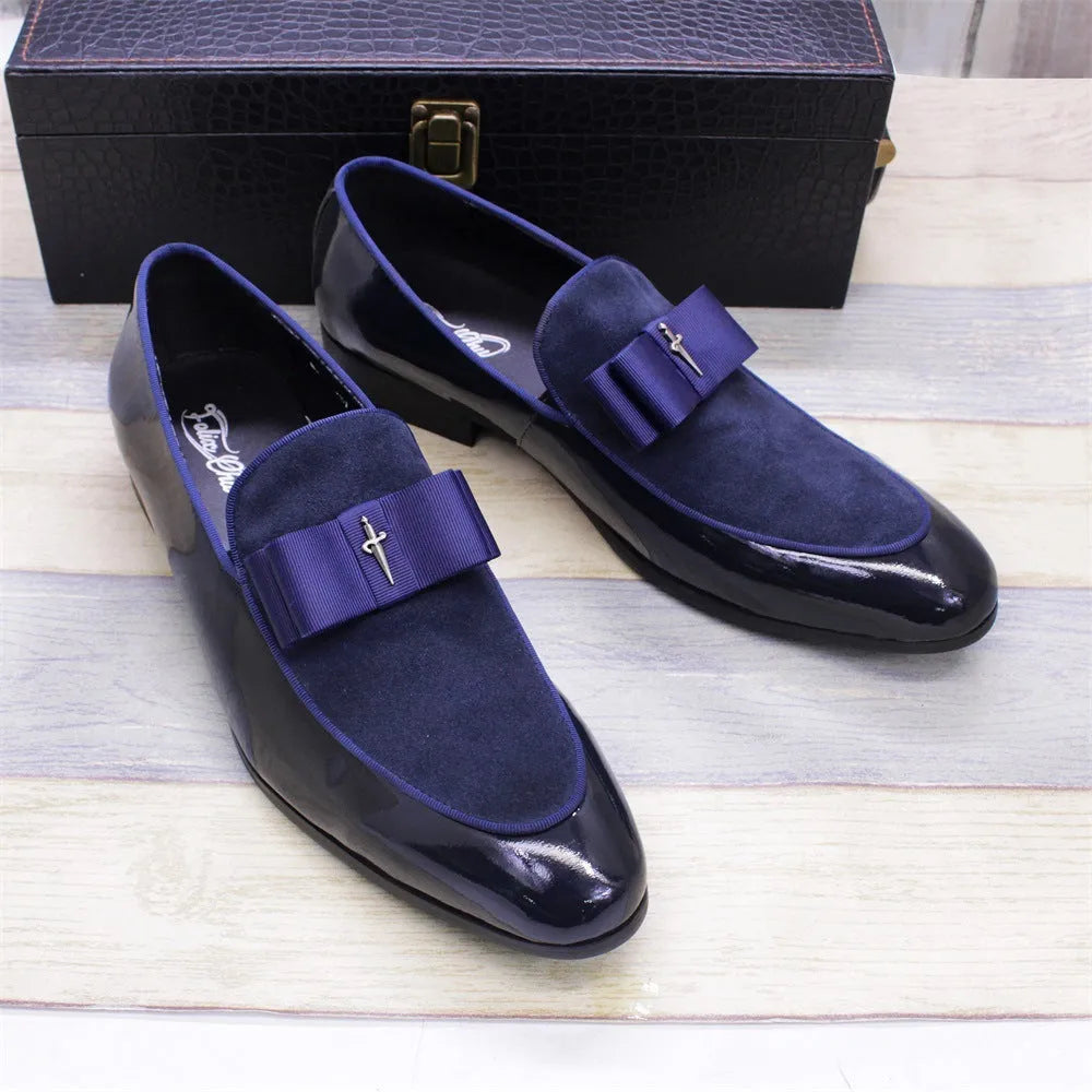 Men's black patent leather low-top shoes with a gold tassel detail on a white background.