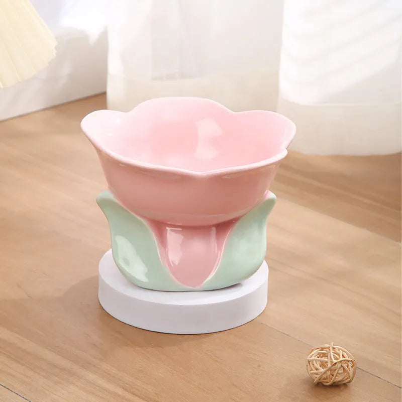 Blue ceramic raised pet bowl with floral pattern and non-slip base for cats or small dogs.