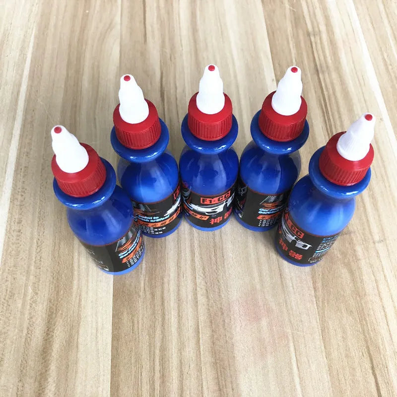 Small blue automotive scratch repair kit with repair agent bottle and applicator sponge for car paint damage