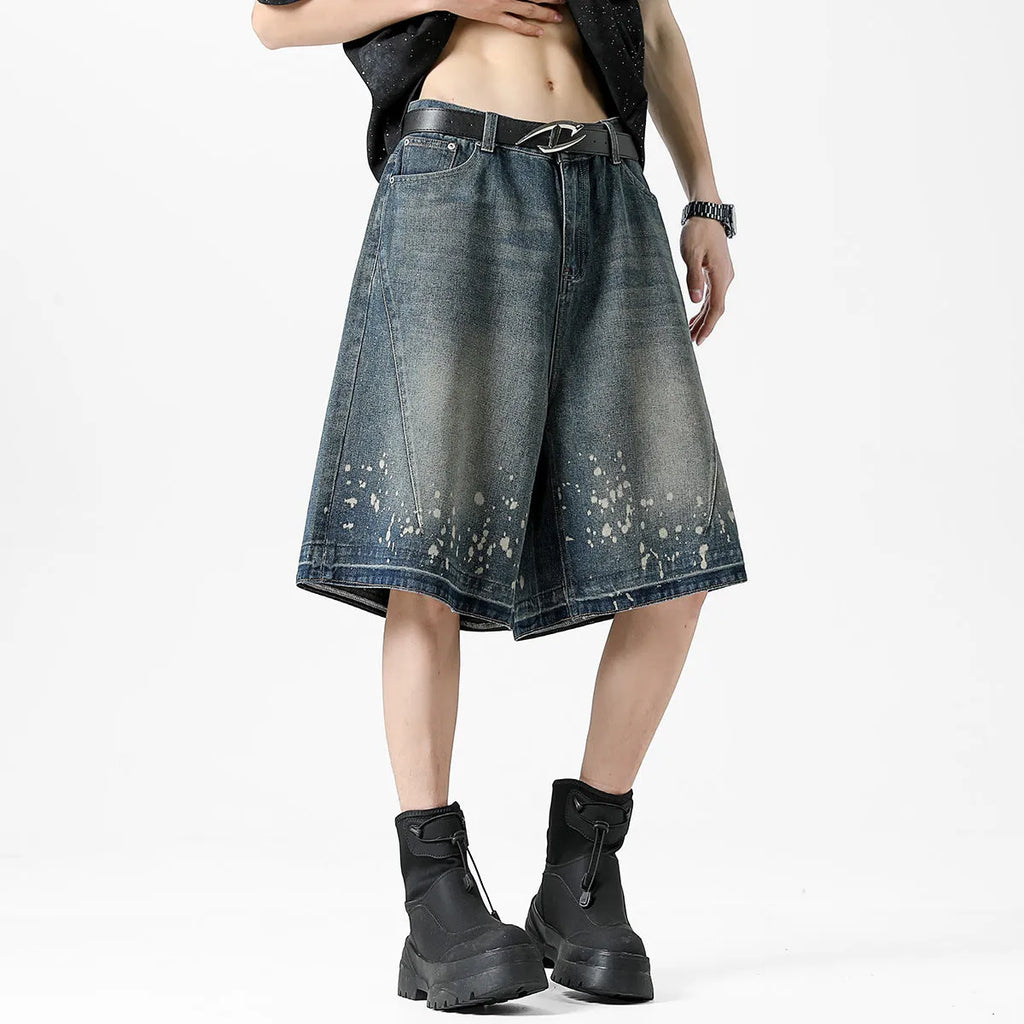 Men's retro blue denim shorts with ripped detailing and splash ink patterns in straight cut design