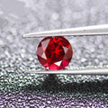 Artificial cultivated ruby gemstones showing pigeon blood red colour in multiple cut styles including round, princess square and water drop