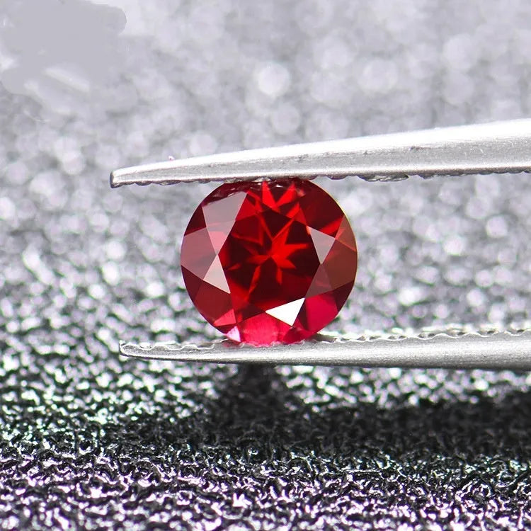 Artificial cultivated ruby gemstones showing pigeon blood red colour in multiple cut styles including round, princess square and water drop