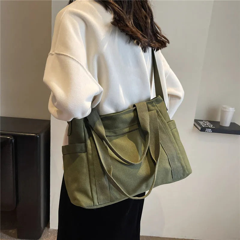 Large capacity polyester canvas shoulder bag in solid colour with sandwich pocket