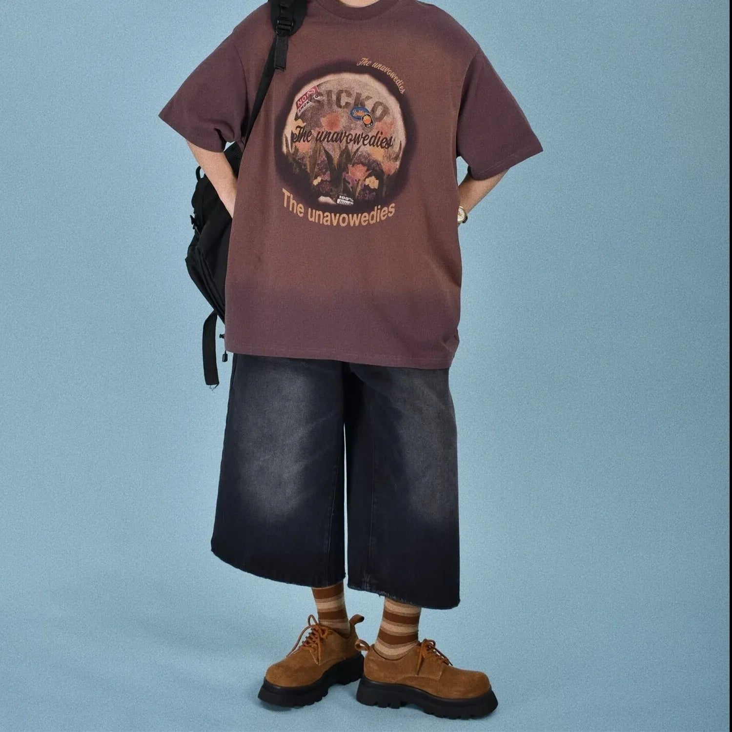 Men's loose straight fit denim shorts in blue, shown on a model for summer.