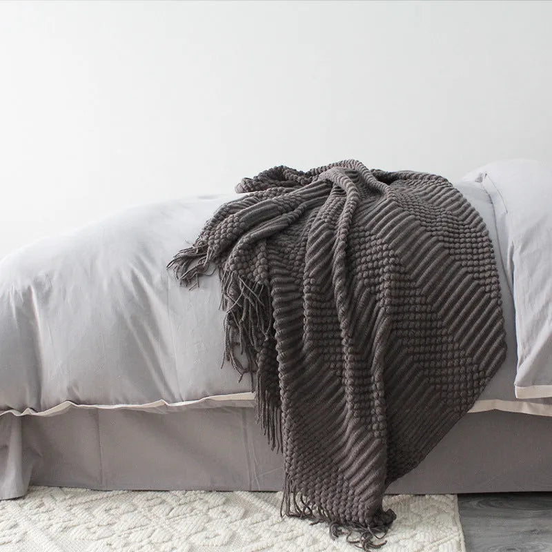 Small light grey polyester blanket folded, showing its texture and 127x170cm size.