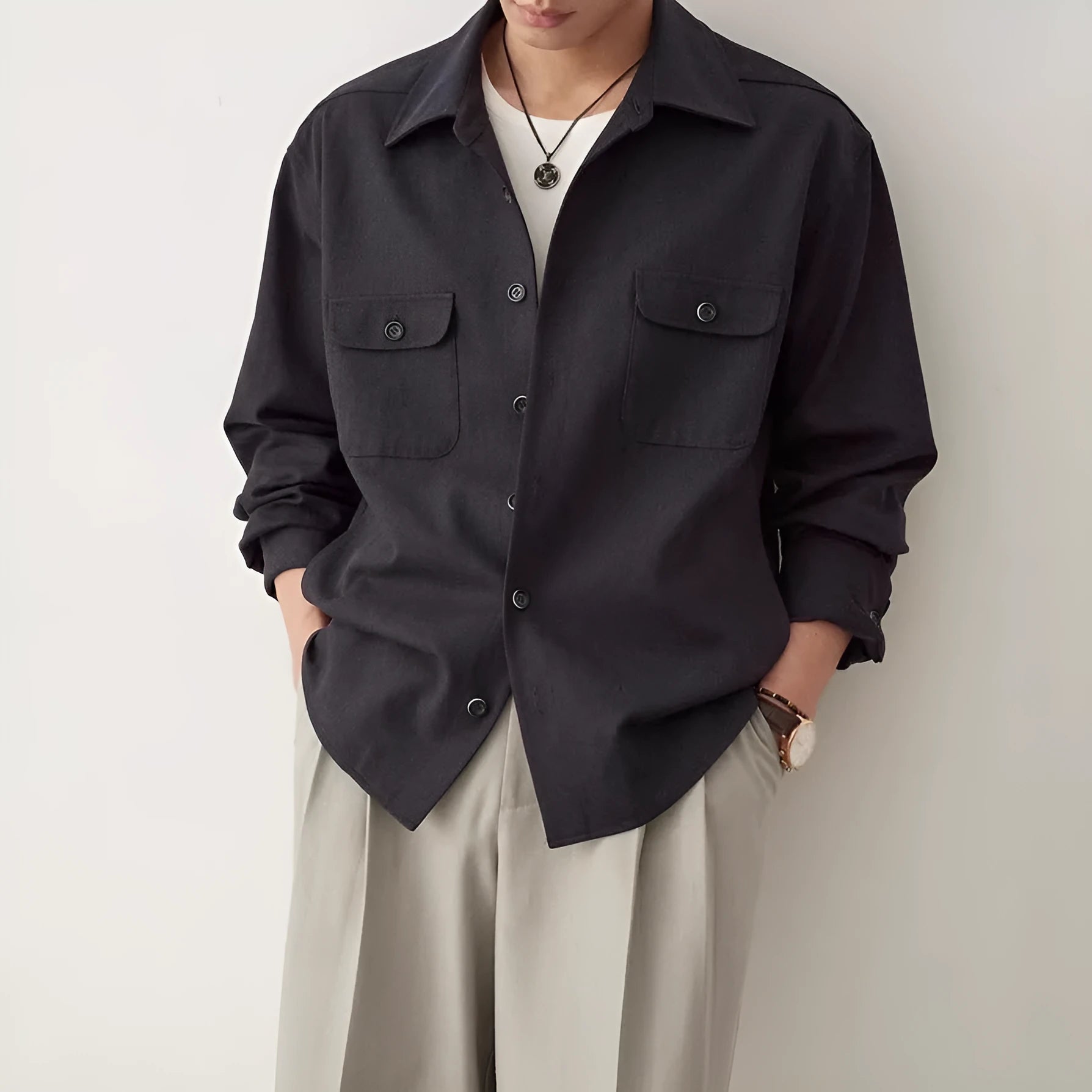 Men's simple profile cotton lapel shirt in light sand rice colour, showing long sleeves and collar detail.