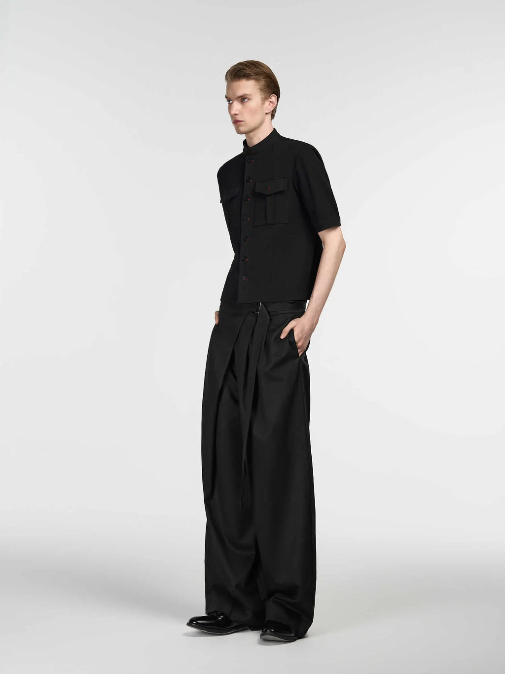 Black women's straight-leg trousers with a single front pleat and adjustable waistband.