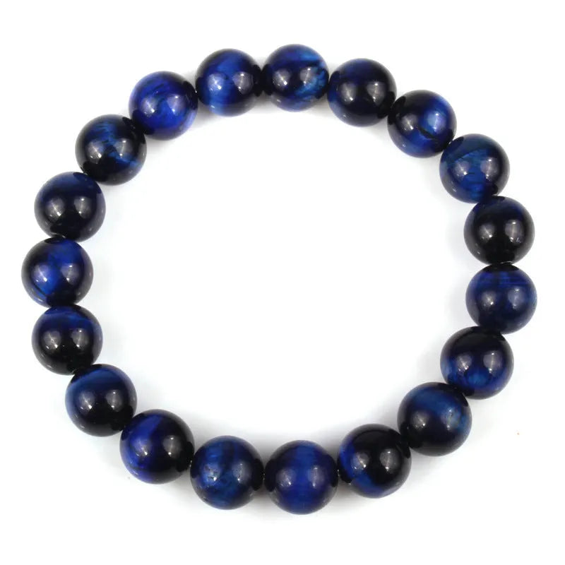 Natural tiger's eye crystal bead bracelet with round beads on a wrist, showing colour variations.