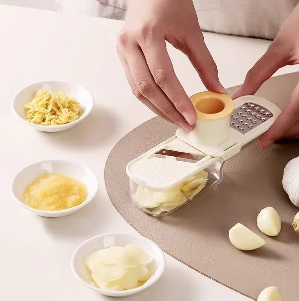 Stainless steel ginger and garlic grinder three-in-one potato slicer in beige on kitchen counter