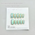 Electroplated cat's eye false nails with aurora glitter on short ladder shapes in sizes XS, S, and M.