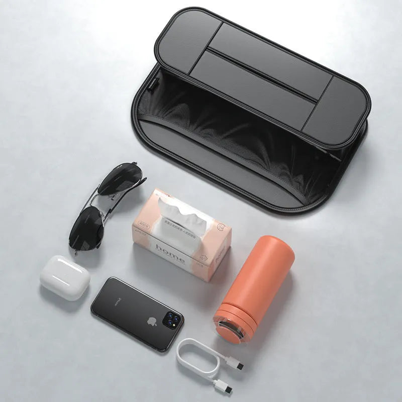 Black leather car seat rear storage bag attached to a vehicle seat, showing its storage box shape.