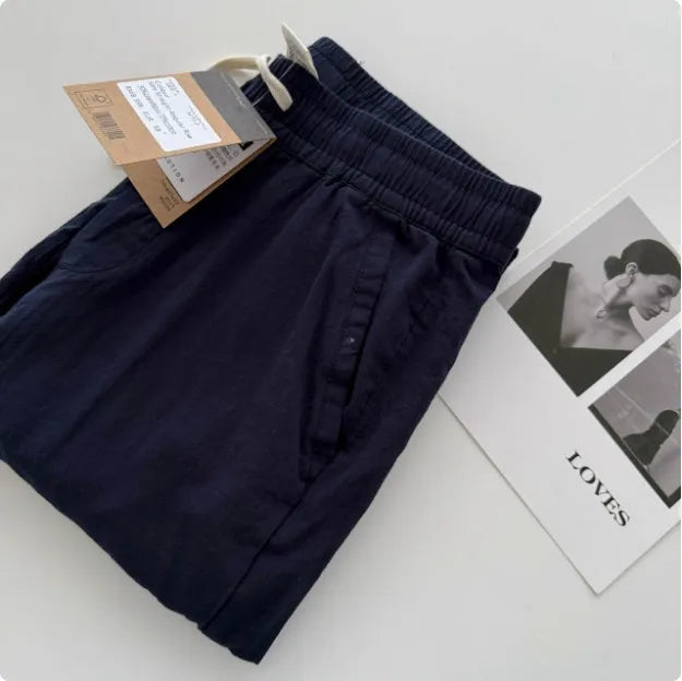 Man wearing beige loose straight-leg casual pants with a drawstring waist, showcasing summer casual style.