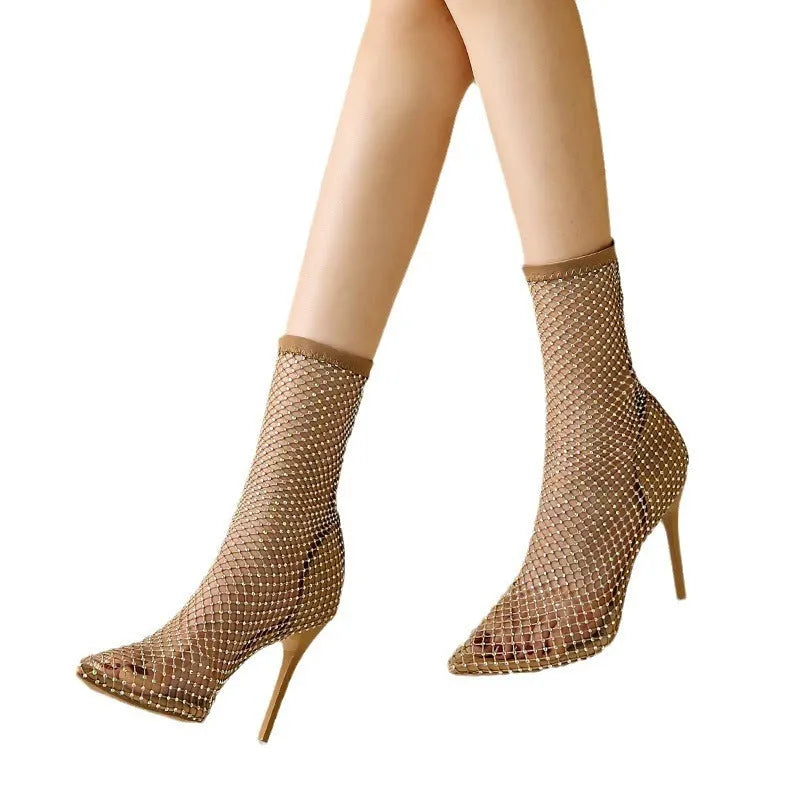 Gold women's high heel sandals with a mesh upper, pointed toe, and stiletto heel on a rubber sole.