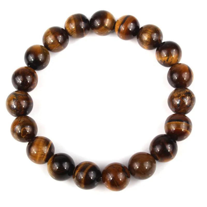 Natural tiger's eye crystal bead bracelet with round beads on a wrist, showing colour variations.