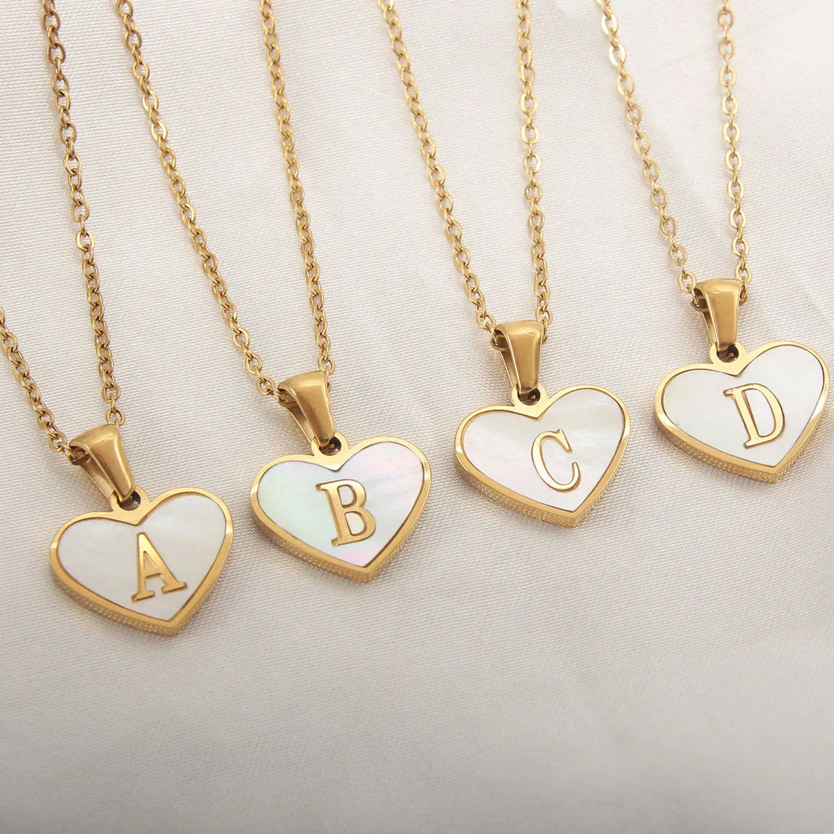 Gold plated heart necklace with white shell detail on an adjustable chain