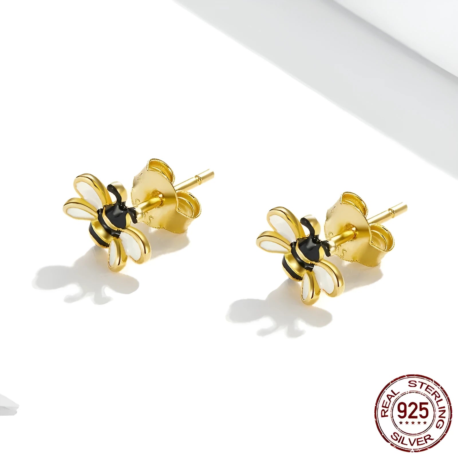 Niche Design S925 silver bee ear studs on a plain background, compact 0.7x0.8cm size