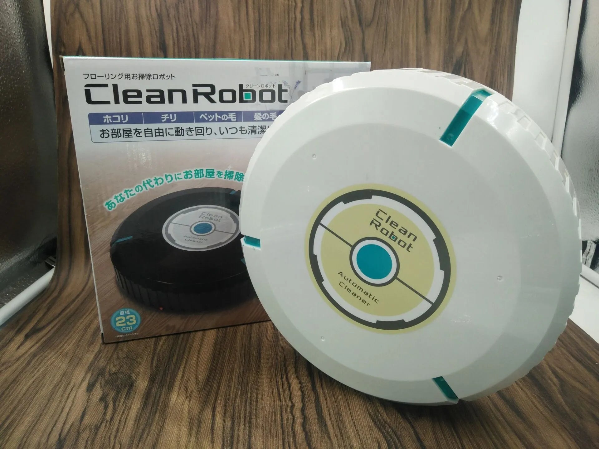 Black or white AC automatic sweeping robot cleaner on a wooden floor