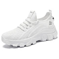 Women's white Flyknit sneaker with thick PVC sole and lace-up closure on a neutral background.
