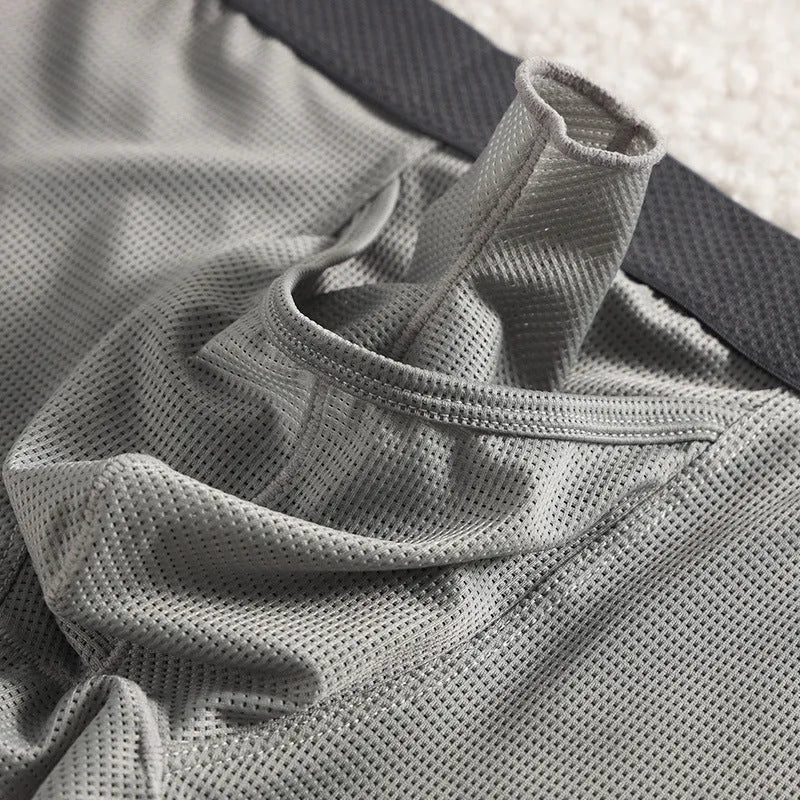 Men's solid colour ice silk boxer shorts showing low waist and breathable mesh fabric.