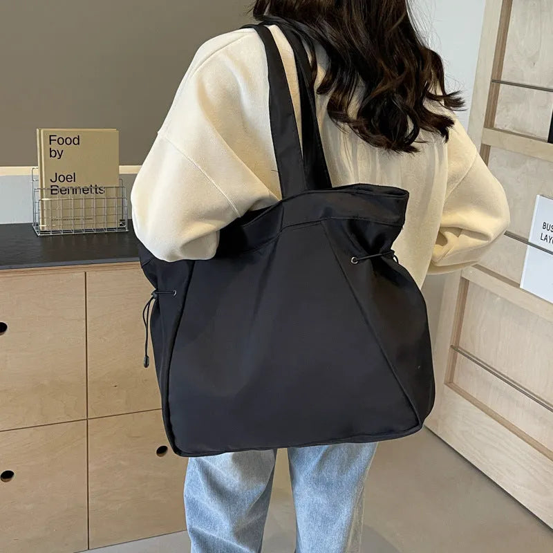 Folding Oxford cloth tote bag in multiple colour options showing compact storage design