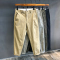 Men's cropped pure cotton casual pants in green, with mid waist and zipper fly.