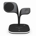 Black wireless charging stand for phone, watch, and headphones on desk with USB cable