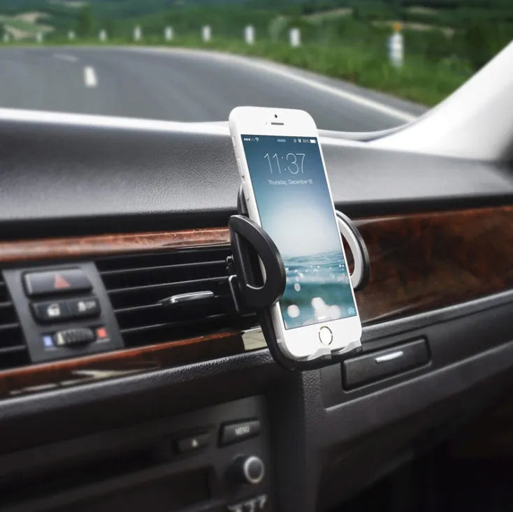 Black plastic mobile phone holder mounted on car air conditioning vent