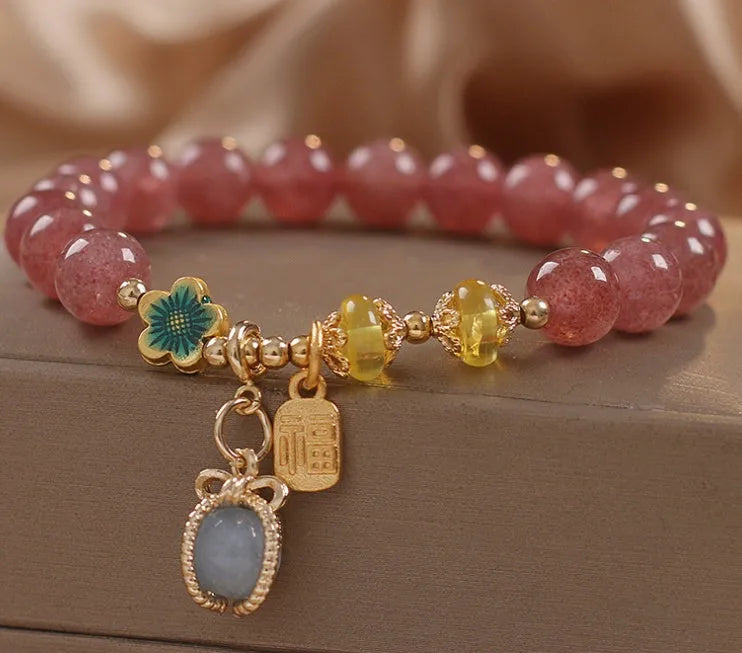 Red strawberry quartz bead bracelet with alloy chain and sparkling rhinestone details.