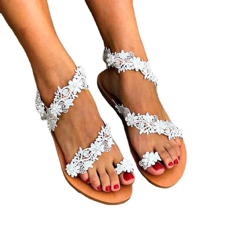 White women's flat shoes with rhinestone flower decoration on patent leather upper