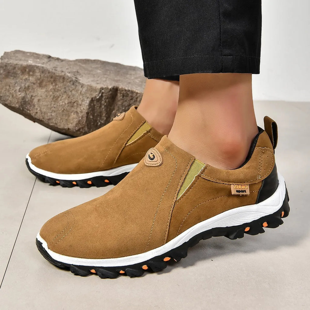 Men's gray round toe slip-on casual shoes with a rubber sole on a plain background.