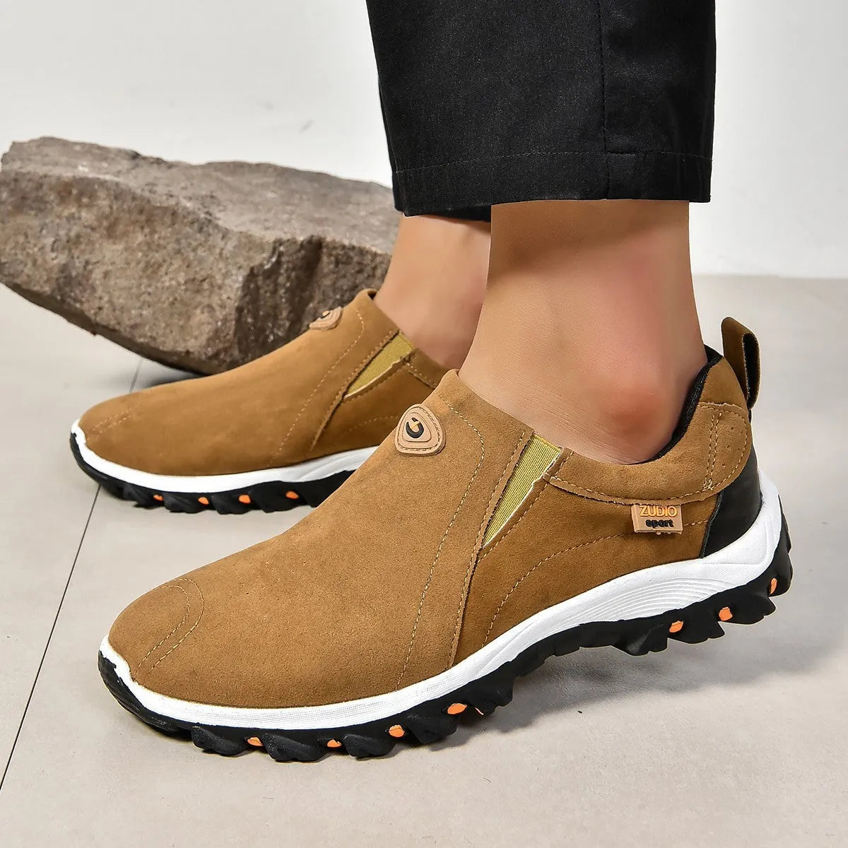 Men's gray round toe slip-on casual shoes with a rubber sole on a plain background.