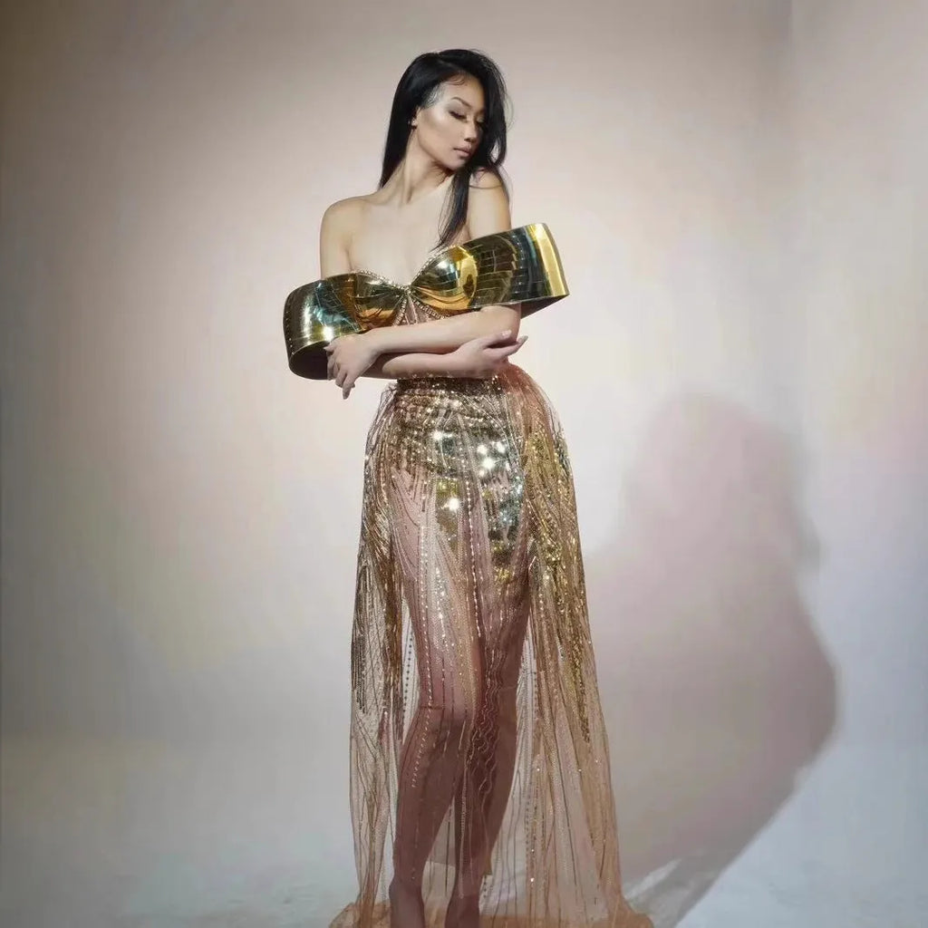 Gold strapless sequin evening dress with high-low hemline and tulle skirt detailing.