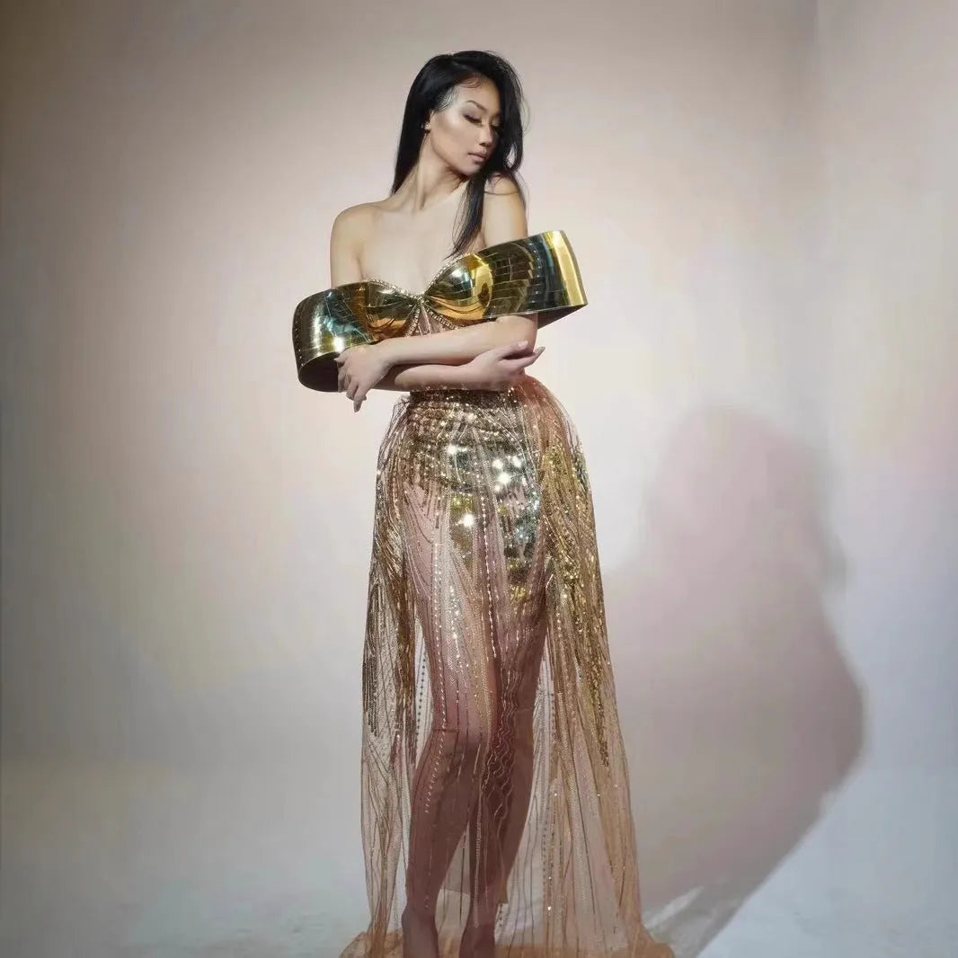 Gold strapless sequin evening dress with high-low hemline and tulle skirt detailing.