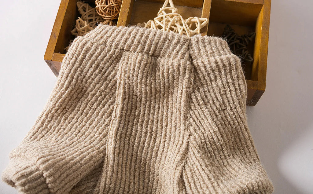 Brown cloth pullover sweater on a small dog, showing casual style.