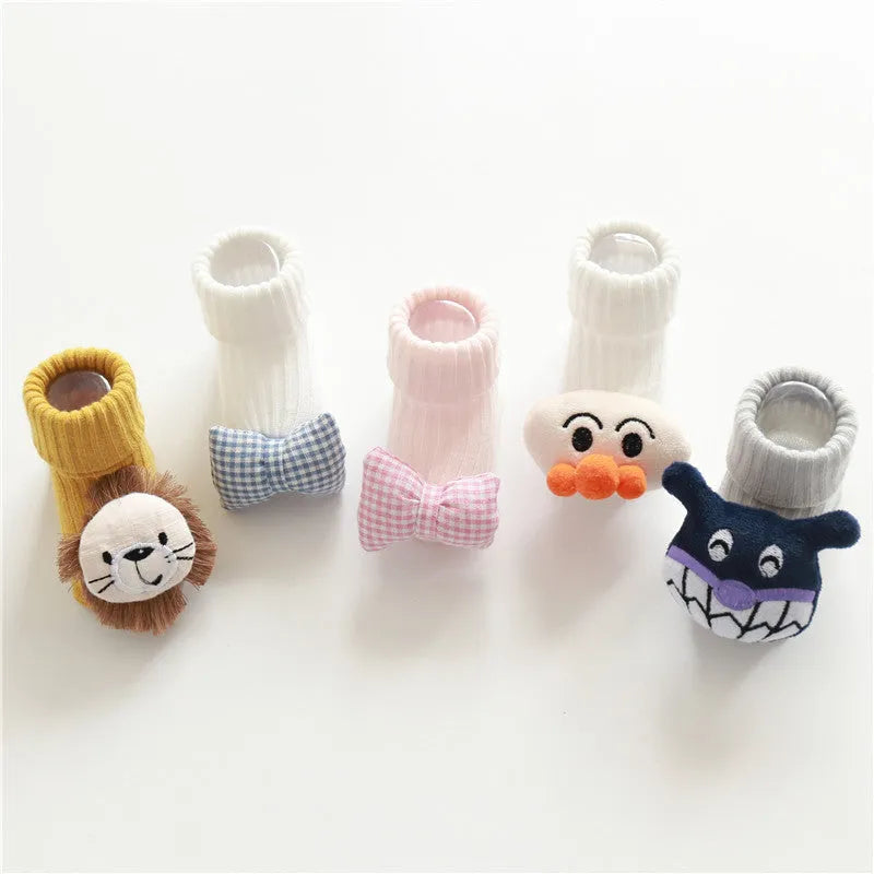 Cotton baby socks in multiple colours including blue bow and pink stars on a white background