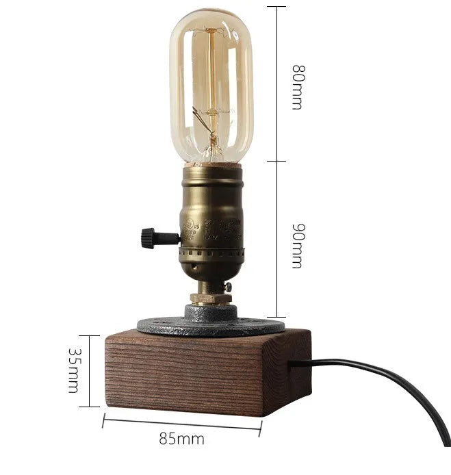 Wood and iron antique water pipe style table lamp on a surface