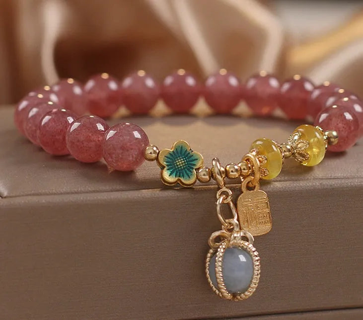 Red strawberry quartz bead bracelet with alloy chain and sparkling rhinestone details.