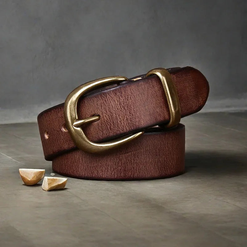 Men's brown genuine cowhide leather belt with a copper pin buckle on a jeans background.