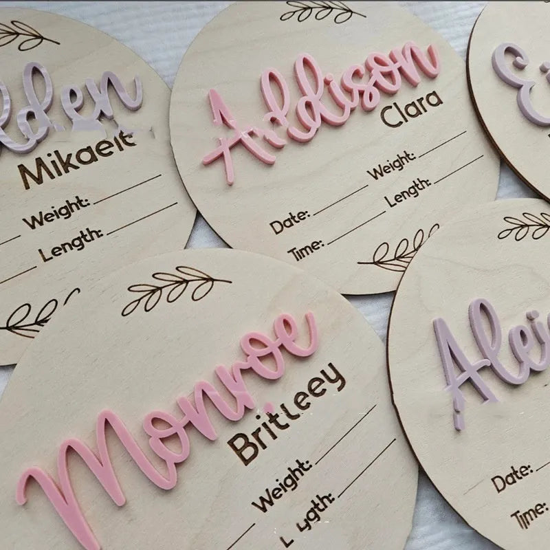Square wooden newborn name label with baby birth information displayed on plywood