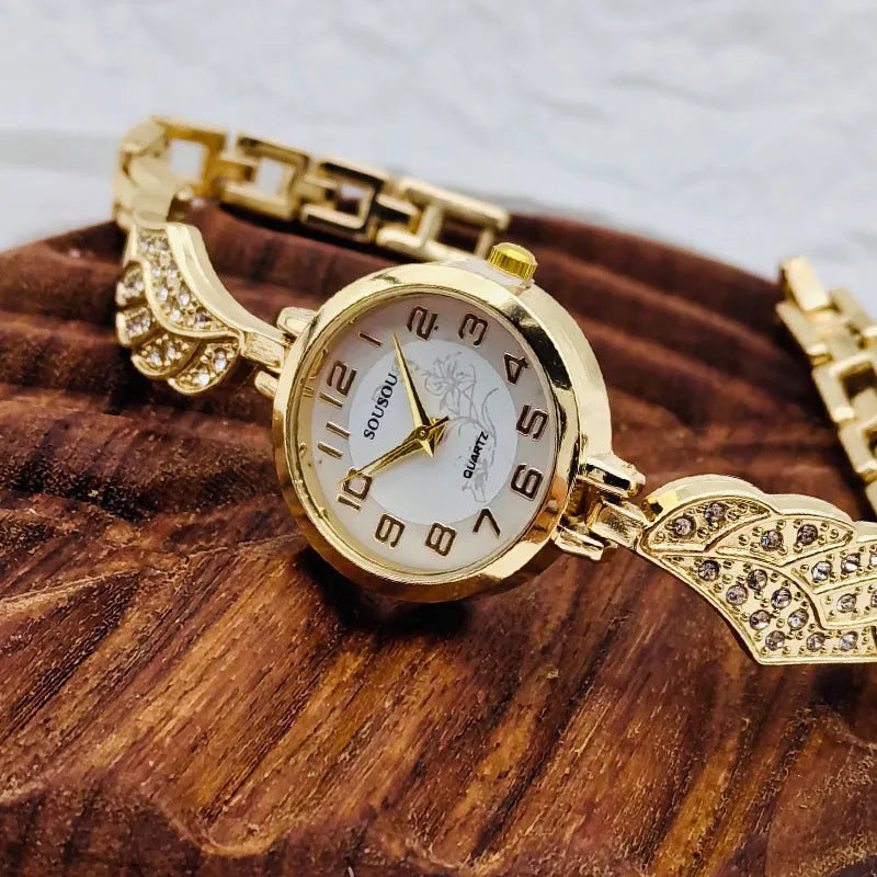 Women's stainless steel watch with round dial on wrist, showing gold face colour option and vachette clasp.
