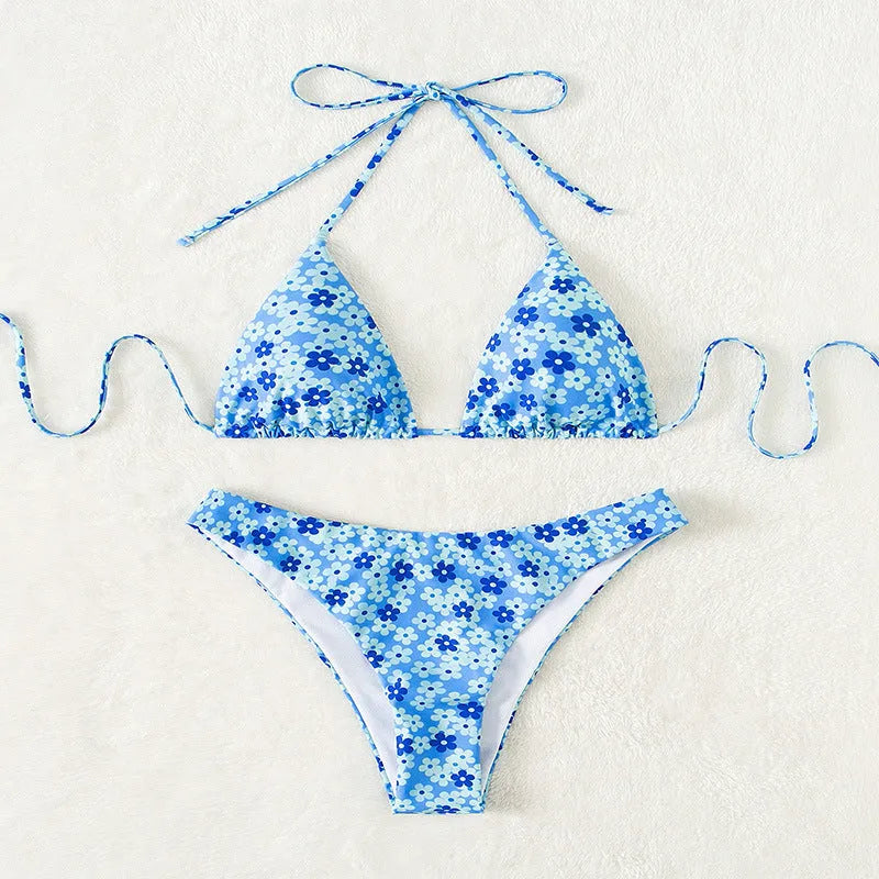 Blue printed women's bikini set with lace-up split top and matching shorts on a neutral background.