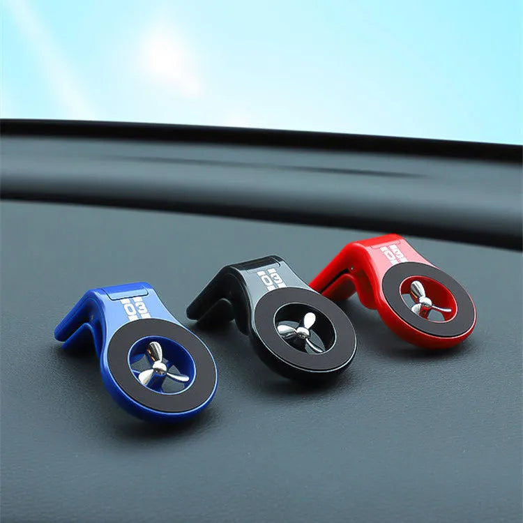Magnetic car phone holder mounted on air vent with smartphone attached and perfume slices