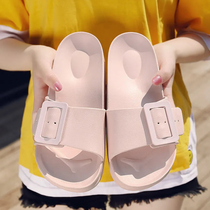 Women's grey blue EVA buckle slippers showing adjustable strap and soft sole.