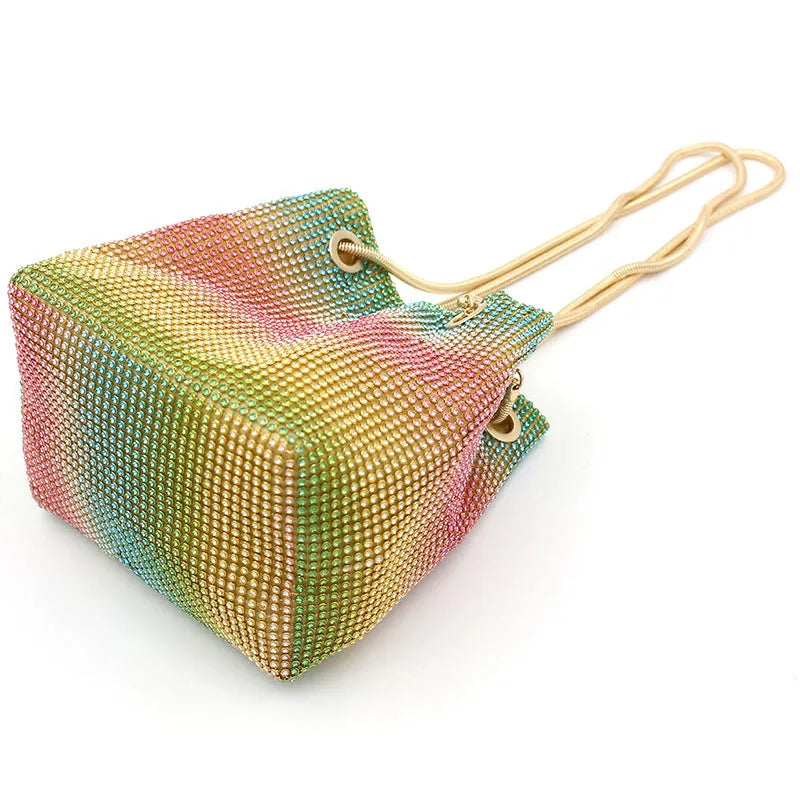 Sparkling rhinestone bucket handbag with a soft, unstructured shape on a neutral background.