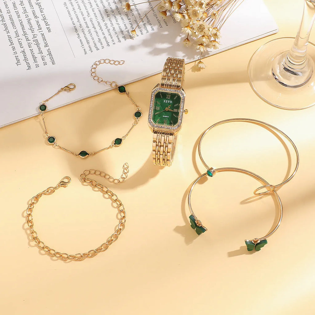 Gold green square women's watch and four matching butterfly bracelets from a five-piece fashion jewellery set.