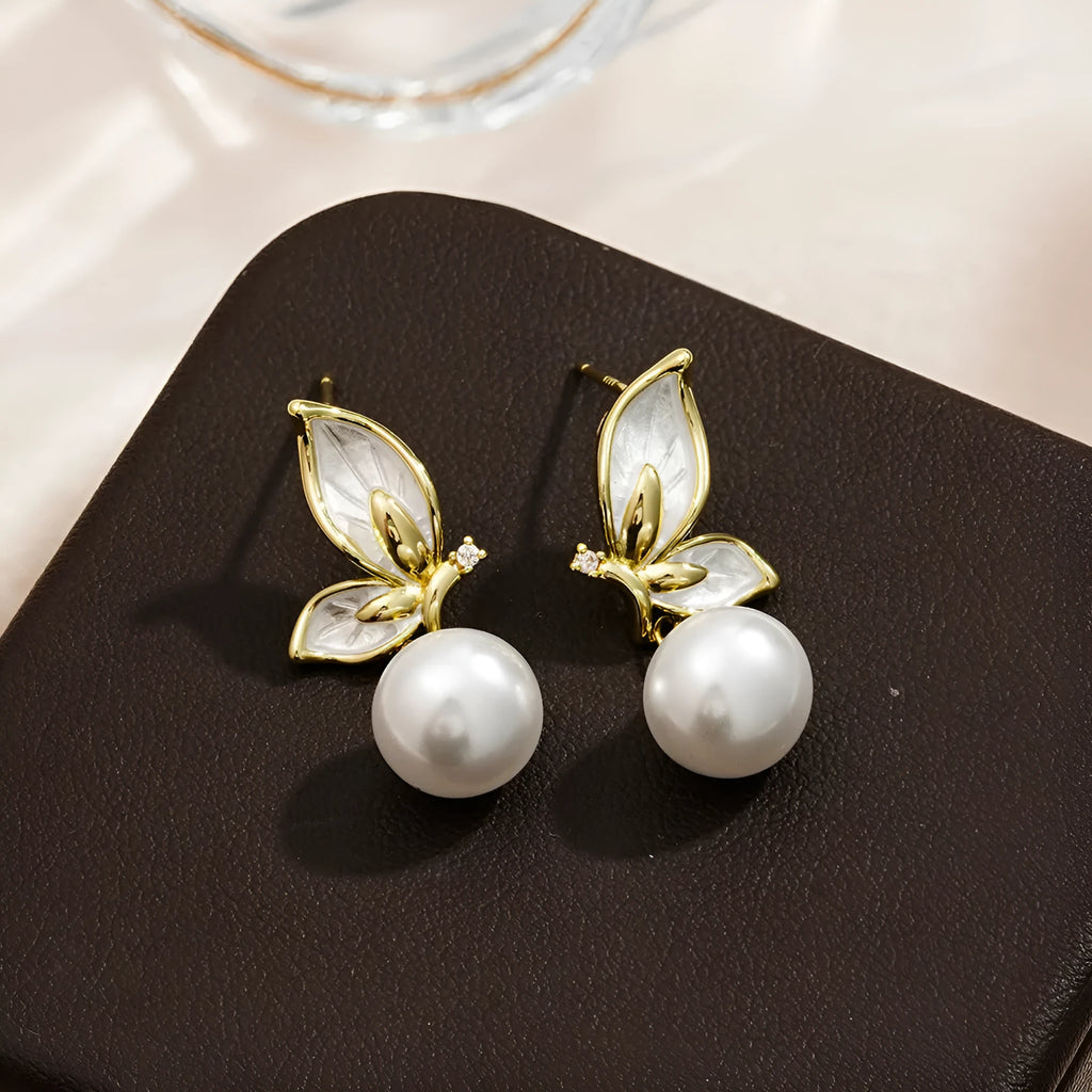 A pair of simple zircon butterfly stud earrings for women with copper electroplated finish.