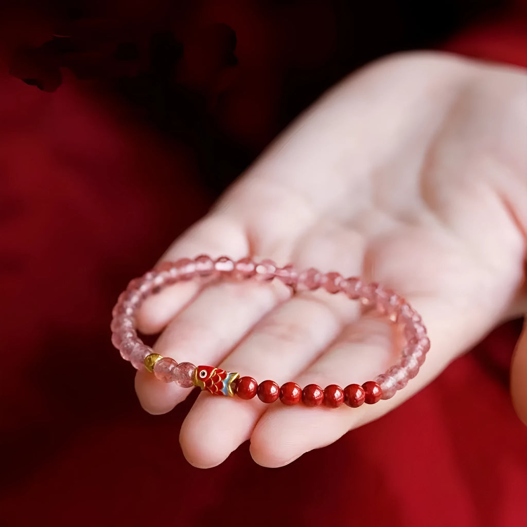 Women's retro bracelet with purple cinnabar and pink strawberry quartz beads on a wrist.