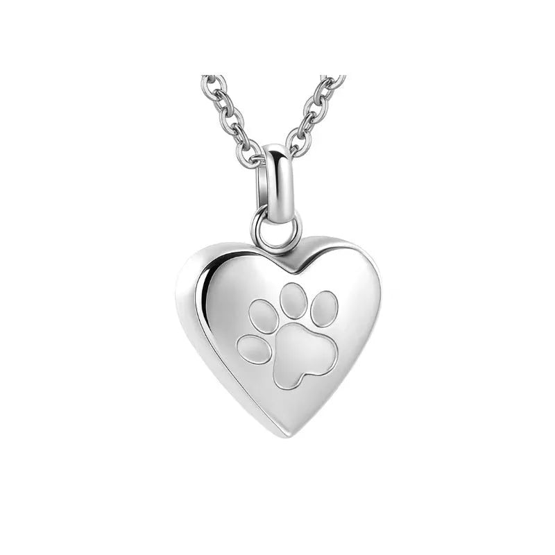 Silver heart-shaped titanium steel necklace with paw print detail and openable compartment.